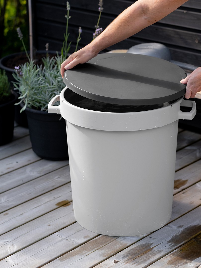 Hands placing a lid on Orthex bin