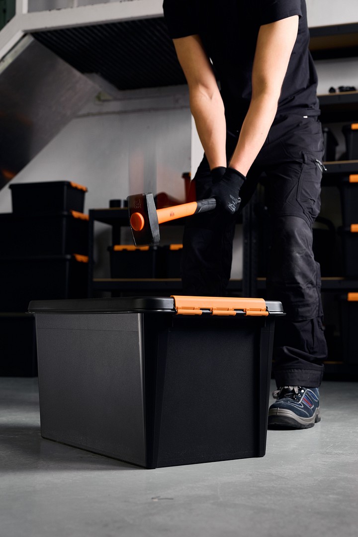 A person hitting SmartStore Pro storage box with a hammer